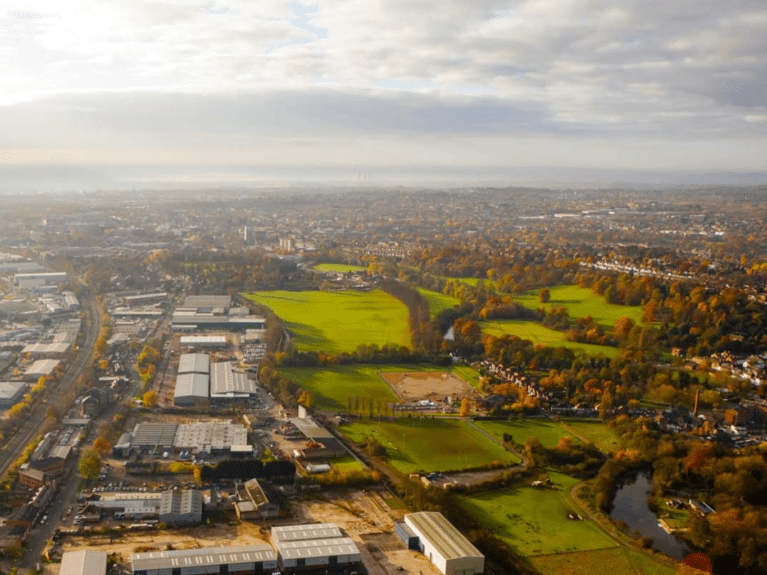 A landscape image showing industrial areas and countryside